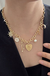 SUN BOW PEARL CROSS DISC U CHARM NECKLACE | 80N1182