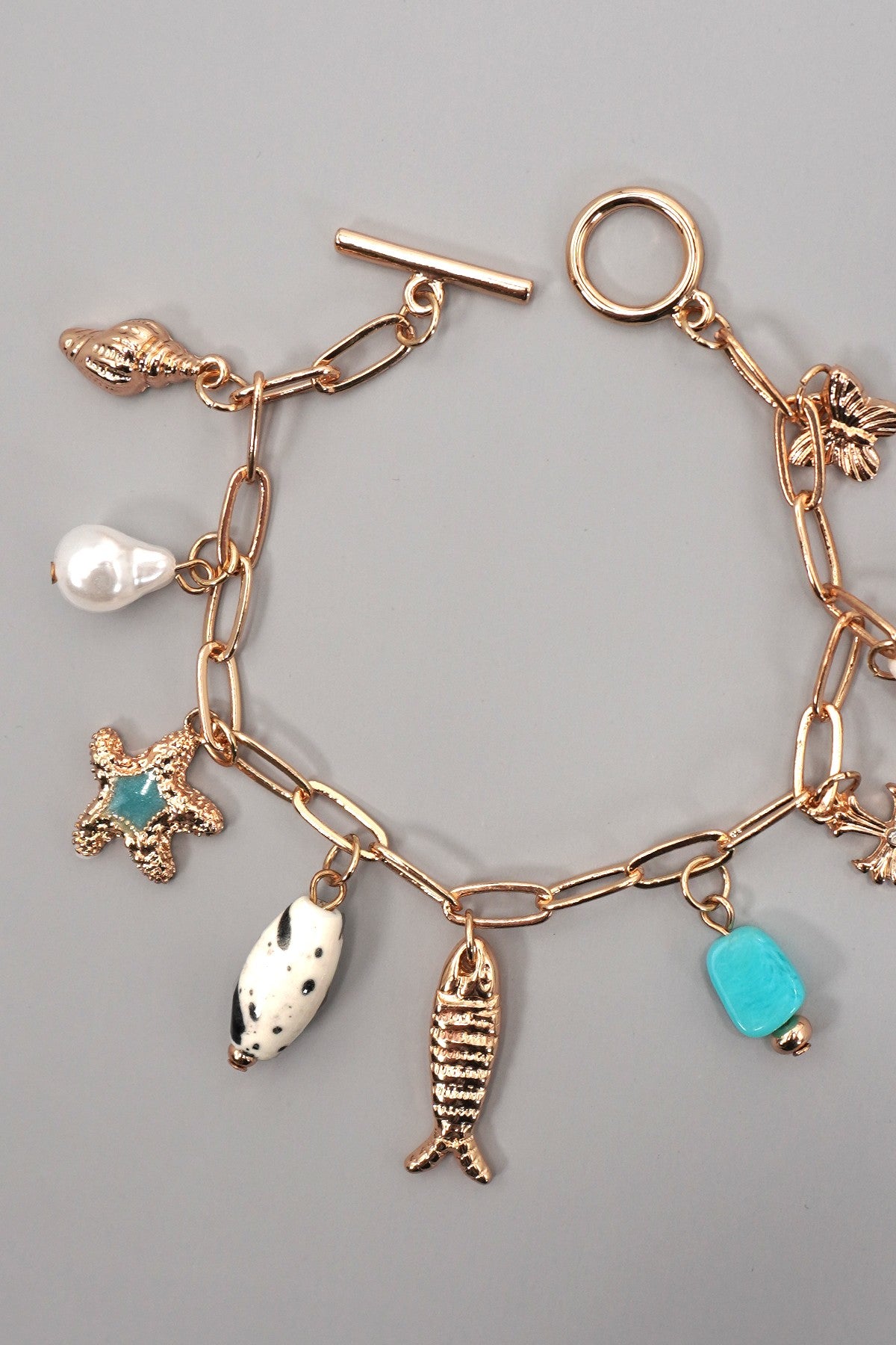 CHARM TOGGLE BRACELET-FISH CROSS CONCH PEARL | 80B1514
