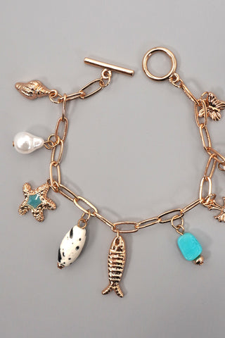 CHARM TOGGLE BRACELET-FISH CROSS CONCH PEARL | 80B1514