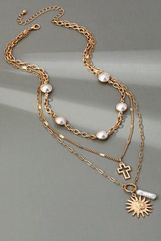 MULTI PEARL LAYER PEARL SUN CROSS CHARM NECKLACE | 80N92503