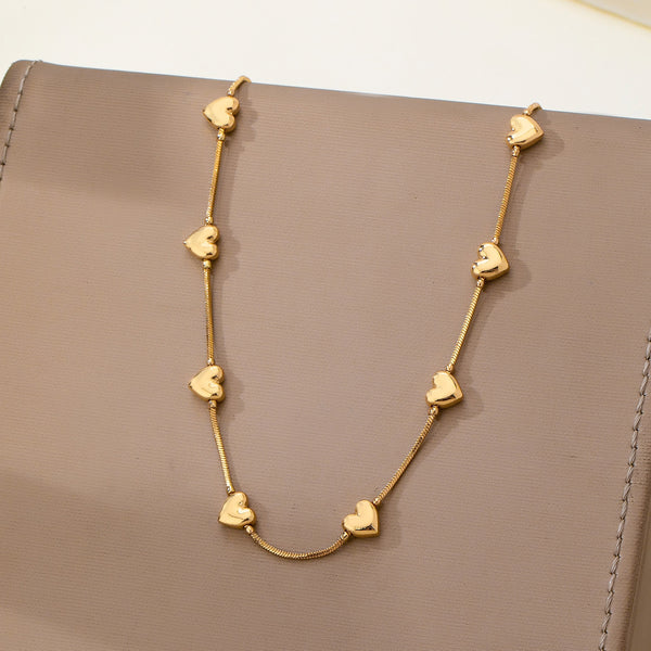 Dainty Gold Puffy Heart Station Necklace | 80N93588